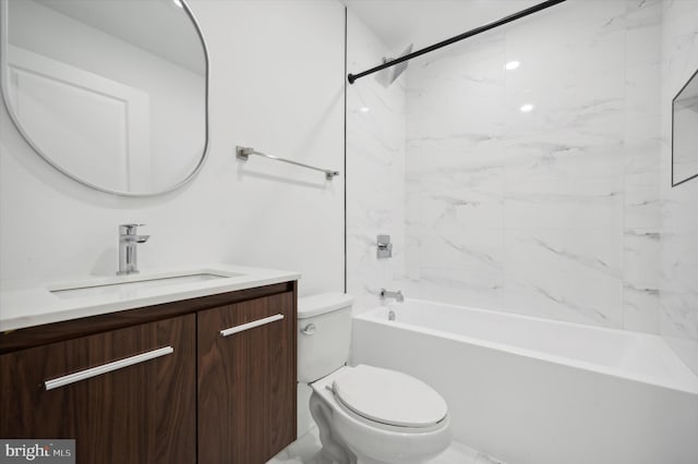 full bathroom featuring tiled shower / bath combo, vanity, and toilet