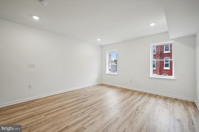 unfurnished room with light wood-type flooring