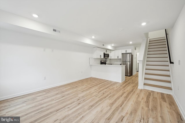 unfurnished living room with light wood-type flooring