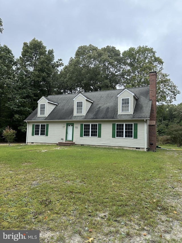 new england style home featuring a front yard