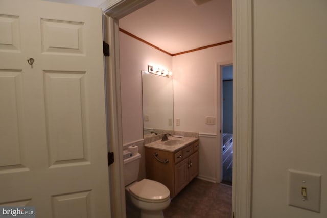 bathroom featuring vanity, crown molding, and toilet