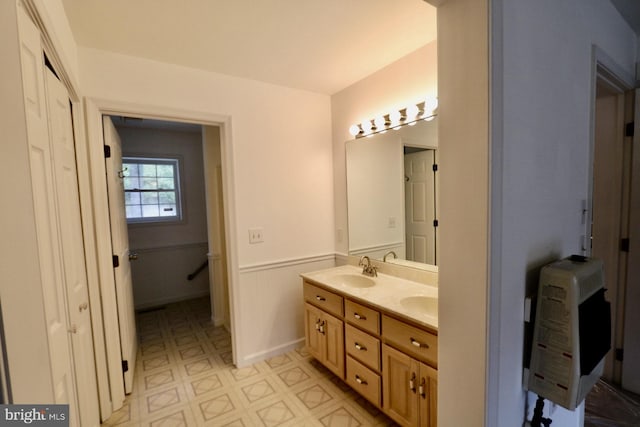 bathroom featuring vanity and heating unit