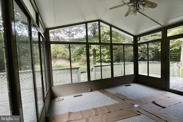 unfurnished sunroom featuring lofted ceiling and ceiling fan