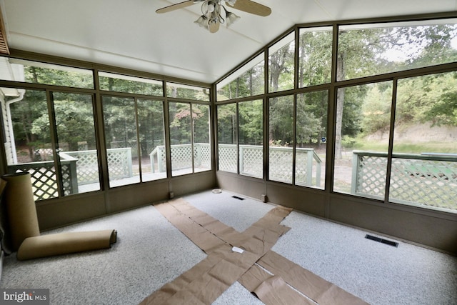 unfurnished sunroom with ceiling fan and plenty of natural light