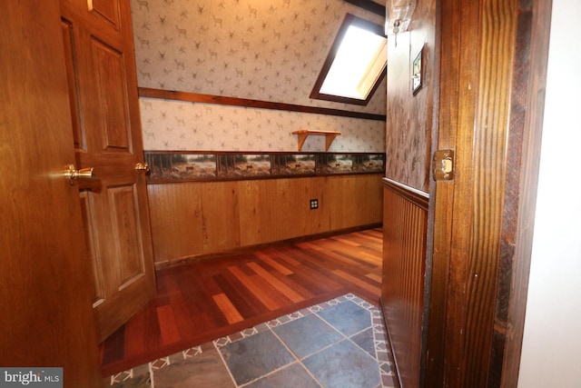 bathroom with wood-type flooring and a skylight