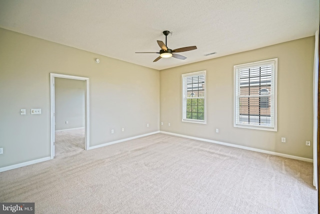 empty room with light colored carpet and ceiling fan