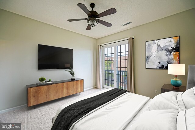 carpeted empty room featuring ceiling fan and a textured ceiling