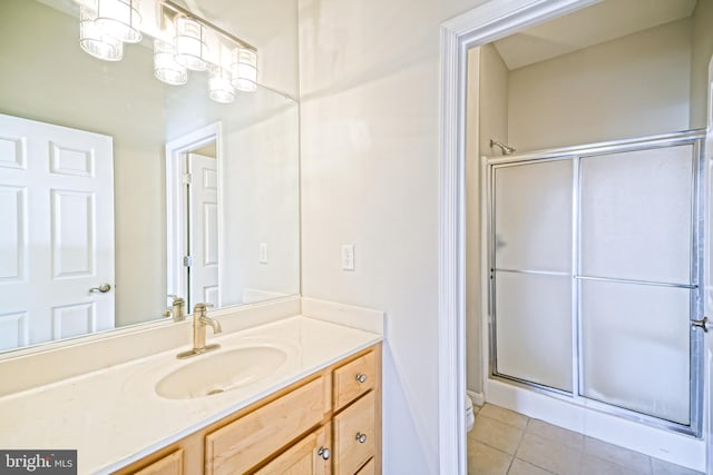 bathroom featuring vanity, tile patterned floors, and a shower with shower door