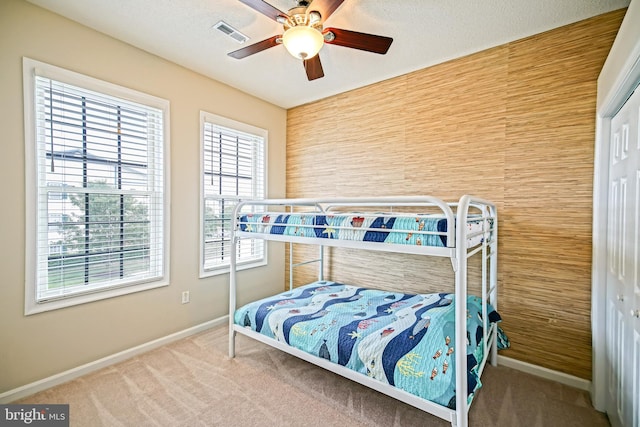 bedroom featuring carpet, ceiling fan, and a closet