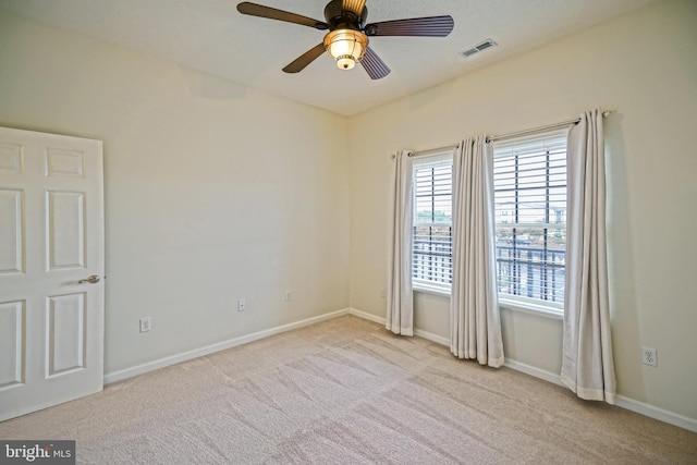 carpeted empty room featuring ceiling fan