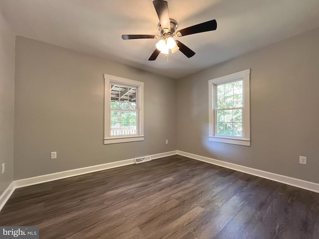 empty room featuring ceiling fan and dark hardwood / wood-style floors