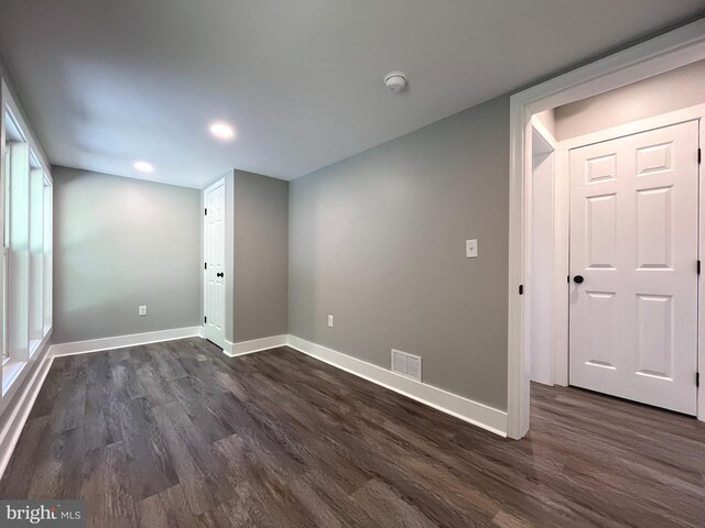 unfurnished room featuring dark hardwood / wood-style floors and a healthy amount of sunlight