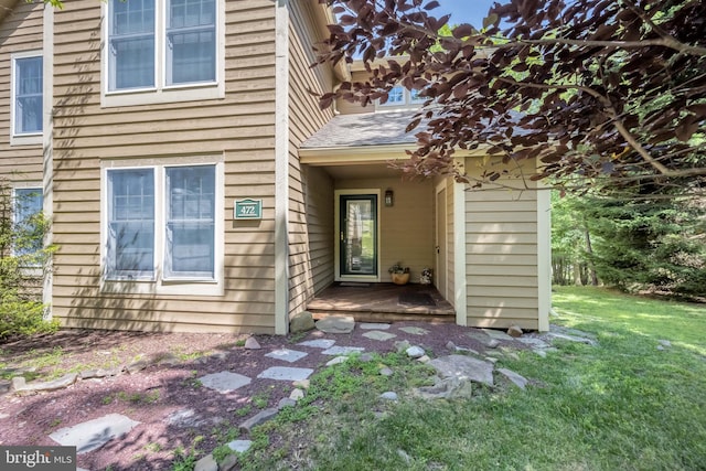 doorway to property featuring a lawn