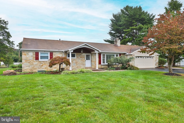 single story home with a front yard and a garage