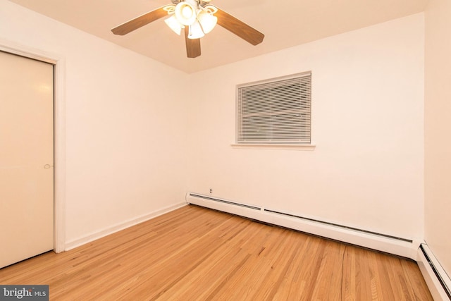 unfurnished room featuring light hardwood / wood-style flooring and a baseboard radiator