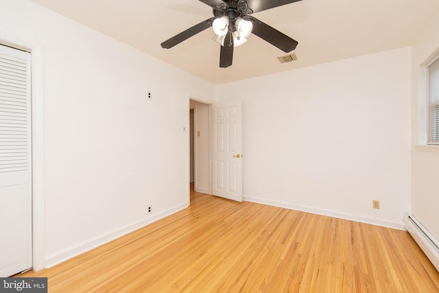 unfurnished bedroom with ceiling fan, a baseboard radiator, light wood-type flooring, and a closet