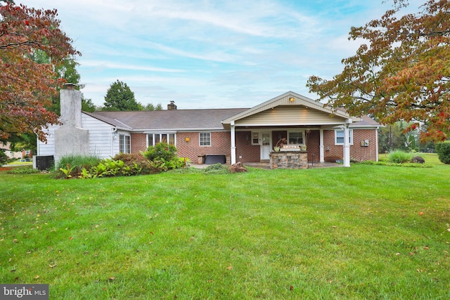 view of front of home with central air condition unit and a front lawn