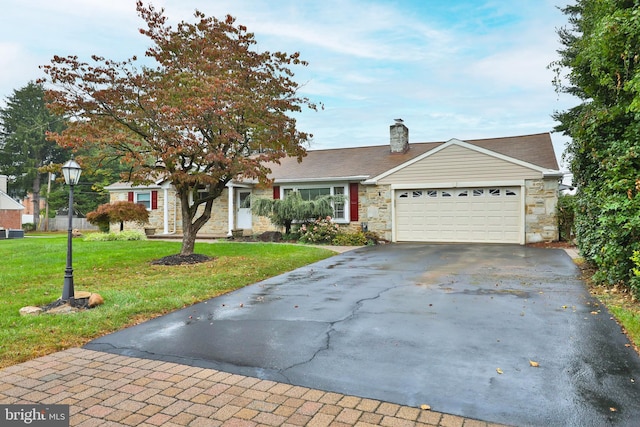 ranch-style house featuring a garage and a front yard