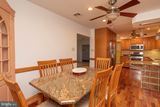 dining room featuring ceiling fan and dark hardwood / wood-style flooring