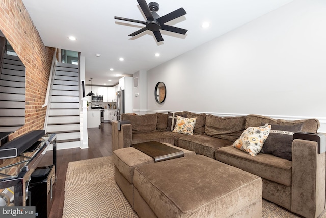 living room featuring wood-type flooring and ceiling fan