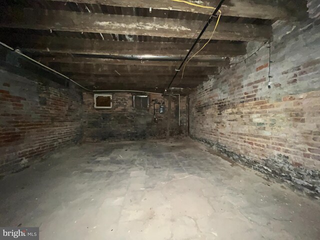 basement featuring brick wall