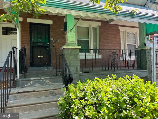 doorway to property featuring covered porch