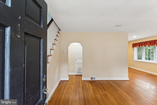 empty room with hardwood / wood-style flooring