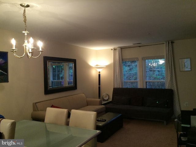 living room with a notable chandelier and carpet floors