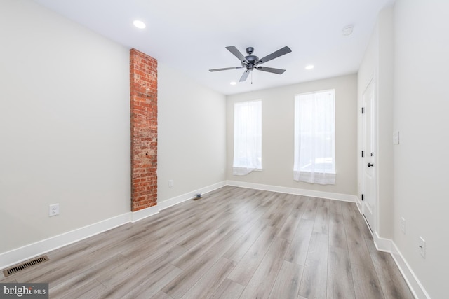 spare room featuring light hardwood / wood-style floors and ceiling fan