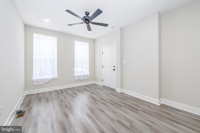 unfurnished room with ceiling fan and light hardwood / wood-style flooring