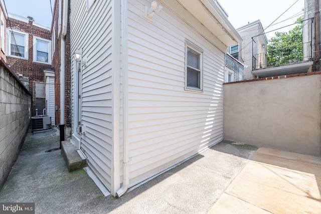 view of side of property featuring a patio and central air condition unit