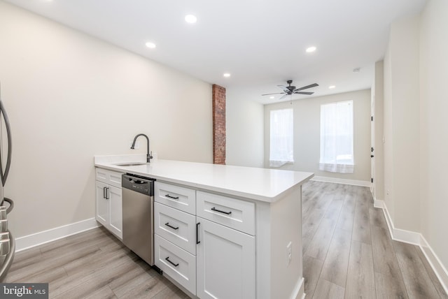 kitchen with white cabinetry, stainless steel dishwasher, ceiling fan, and sink