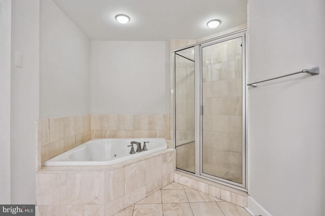 bathroom featuring a stall shower, tile patterned floors, and a whirlpool tub