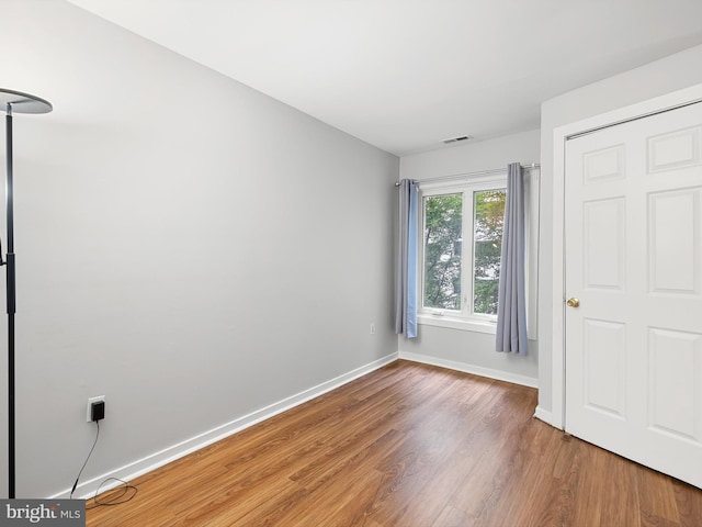 unfurnished bedroom with wood-type flooring