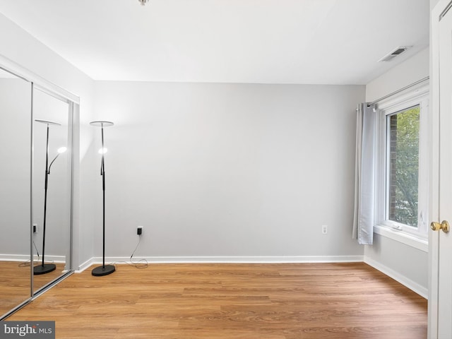 empty room with light hardwood / wood-style floors