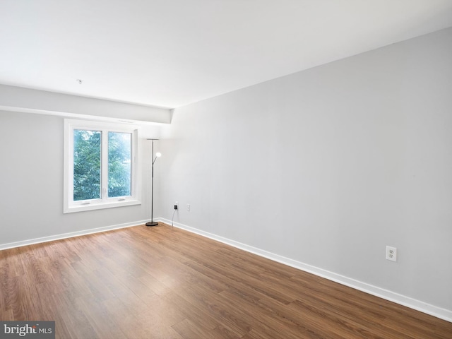 unfurnished room with hardwood / wood-style flooring