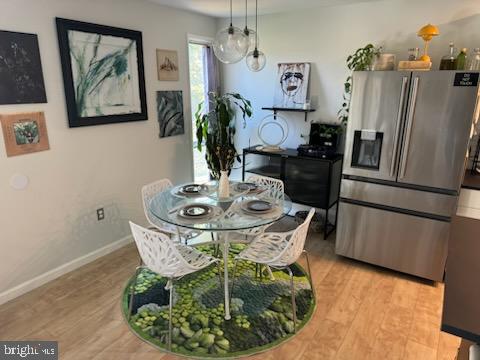 dining space featuring an inviting chandelier and light hardwood / wood-style floors