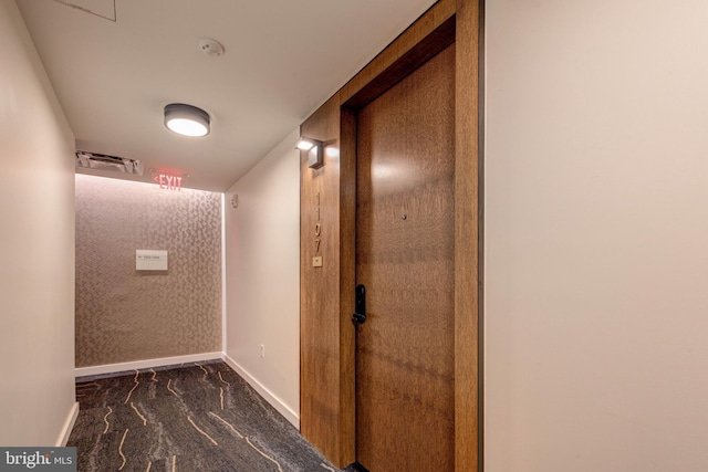 hallway with dark carpet