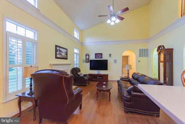 living room with high vaulted ceiling, ceiling fan, and hardwood / wood-style flooring