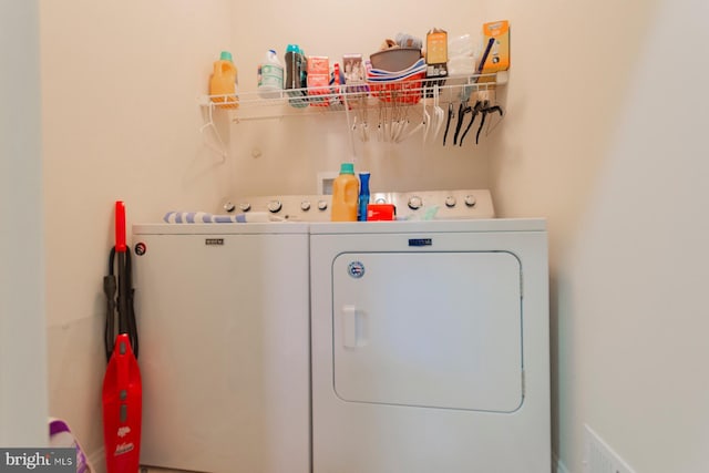 clothes washing area featuring washer and clothes dryer