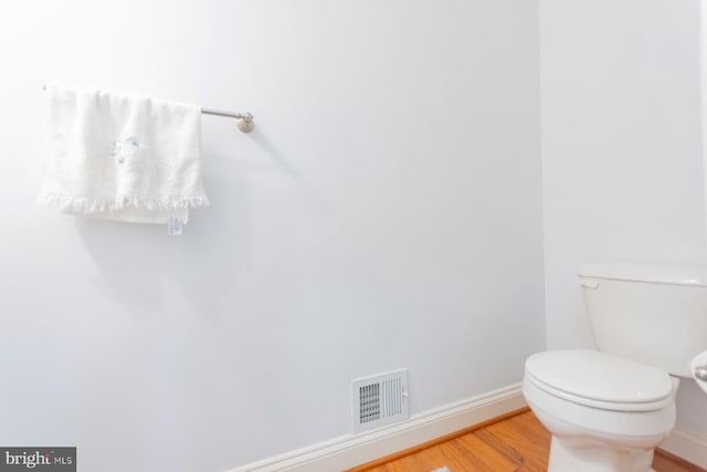 bathroom featuring hardwood / wood-style flooring and toilet