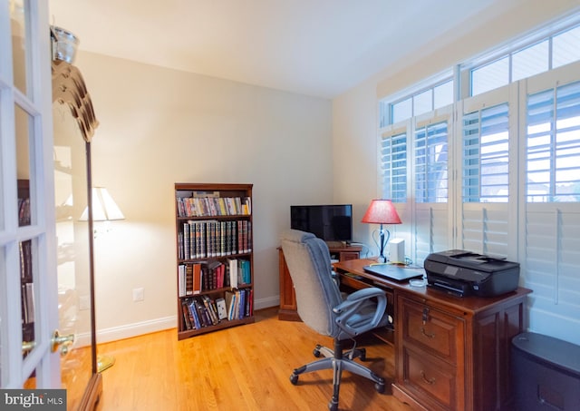 office with light hardwood / wood-style flooring