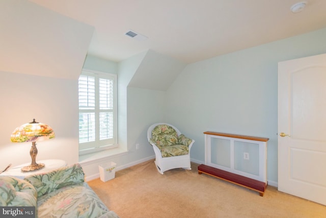 sitting room featuring light carpet and lofted ceiling