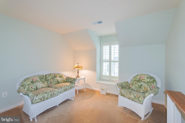 living area with light carpet and lofted ceiling