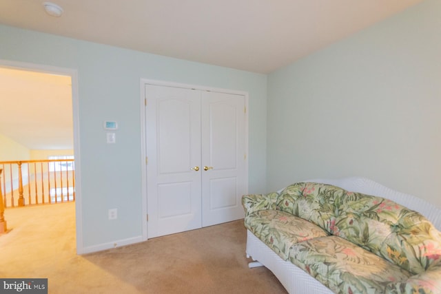 sitting room featuring light carpet