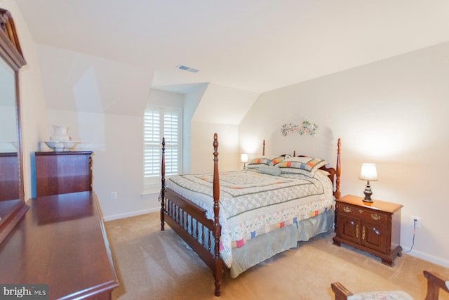 carpeted bedroom with lofted ceiling