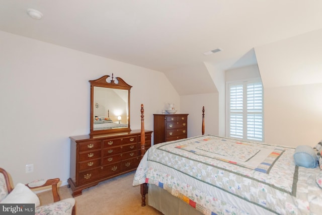 carpeted bedroom featuring lofted ceiling