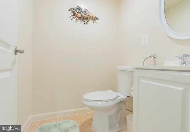 bathroom featuring tile patterned floors, vanity, and toilet