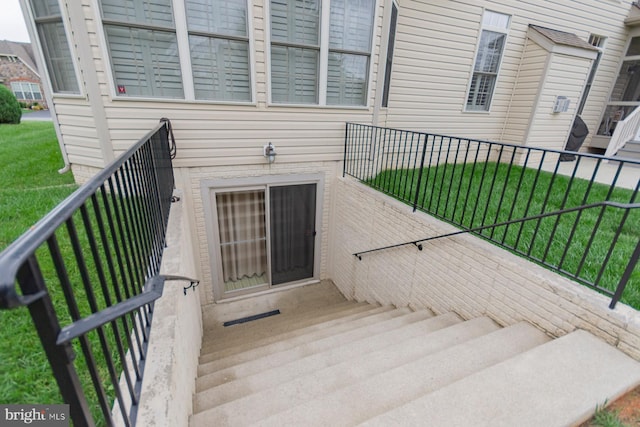 doorway to property featuring a yard