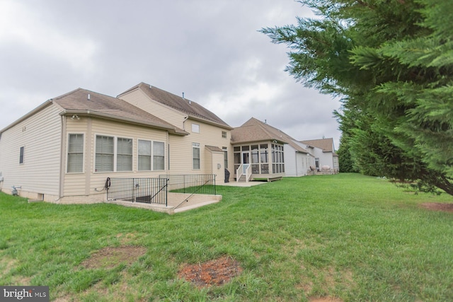 rear view of property with a lawn and a patio area